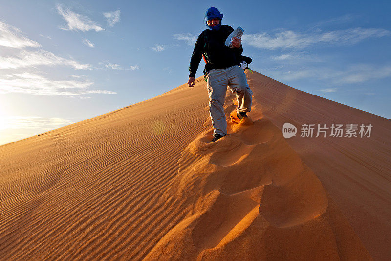 在非洲摩洛哥日出的Erg Chebbi沙丘上的人